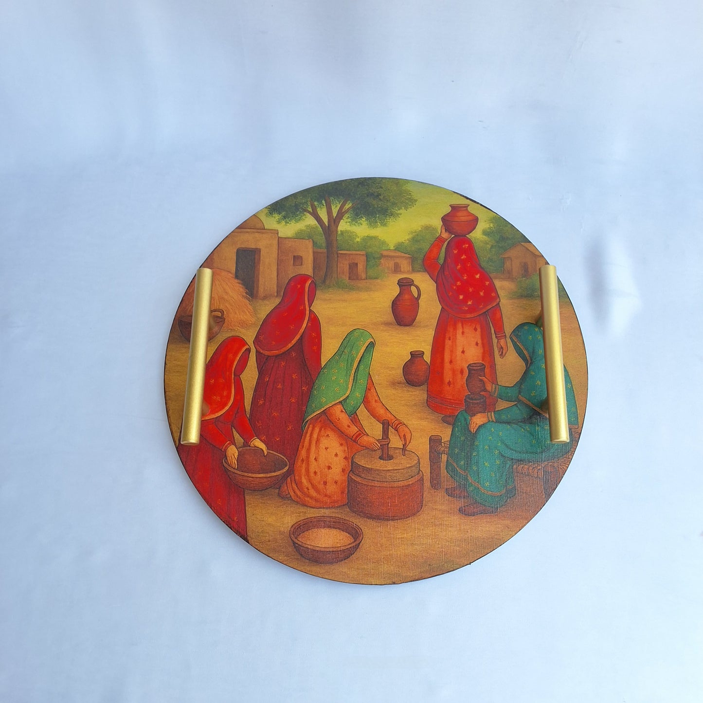 round wooden tray. digitally printed with picture of a Pakistani village showing Pakistani village women doing chores. serving tray, decorative tray. Pakistani culture