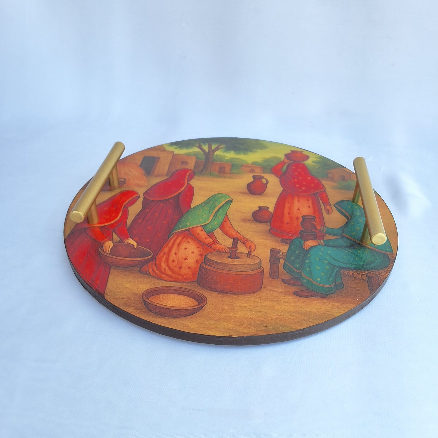 round wooden tray. digitally printed with picture of a Pakistani village showing Pakistani village women doing chores. serving tray, decorative tray