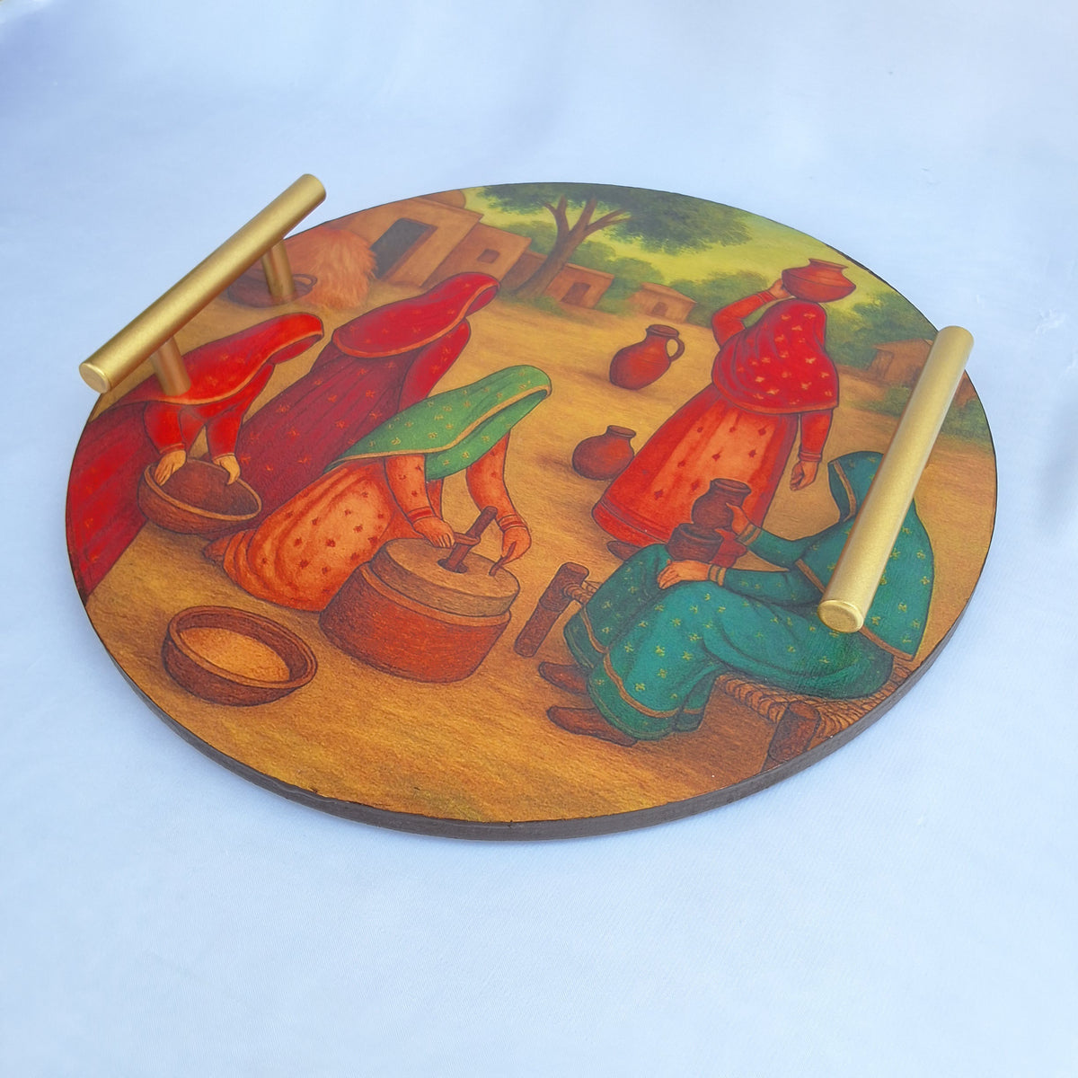 round wooden tray. digitally printed with picture of a Pakistani village showing Pakistani village women doing chores. serving tray, decorative tray